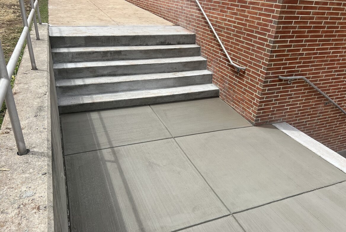 Finished commercial concrete steps with handrails, wide angle